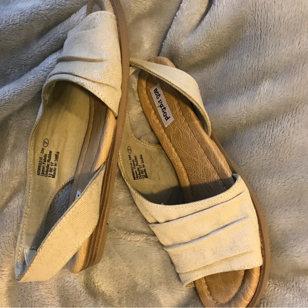 Not Rated sandal beige with gold speck and flat heel.